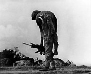 A freedom fighter carries his wounded comrade.