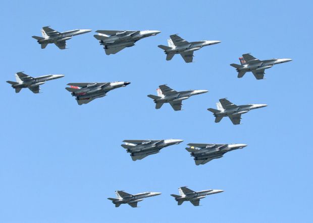 8 F-18 and 4 F-14 fighters in formation