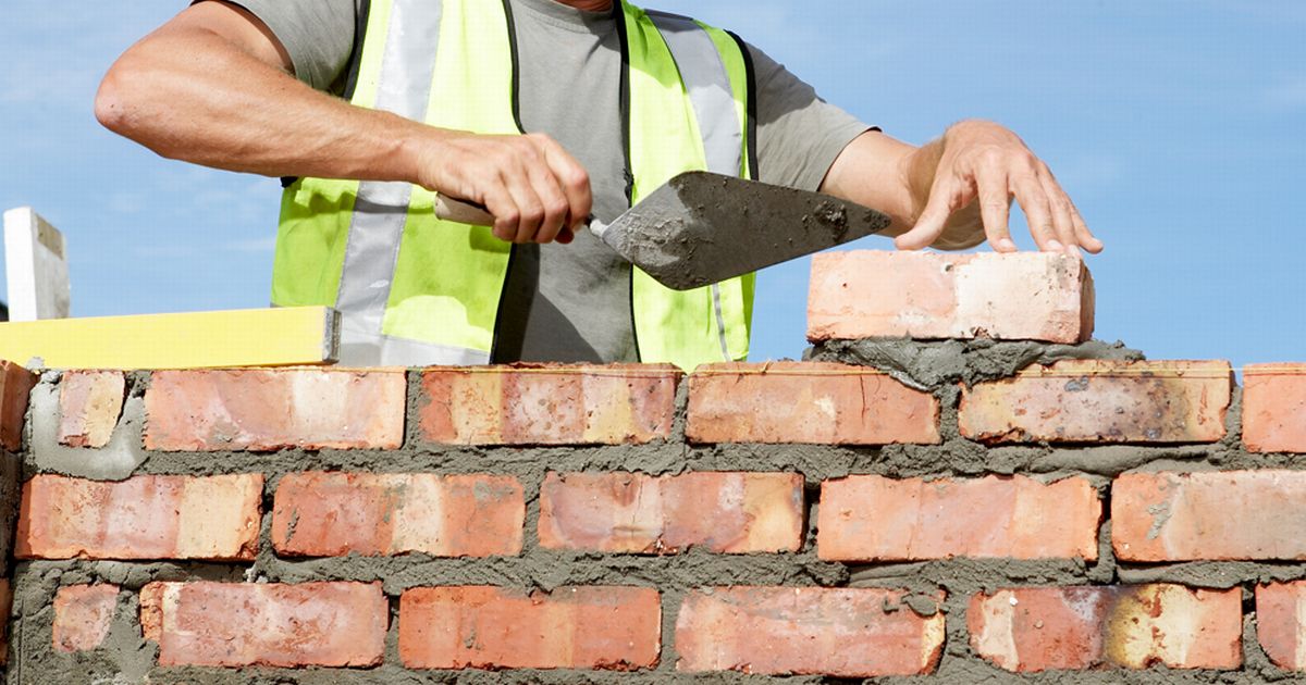 Builder laying bricks